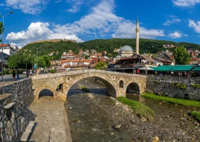 The historic stone bridge of Prizren with the old town and mosque in the background, Kosovo.