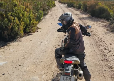 Adventure rider stopped on a remote mountain dirt road in South Africa.