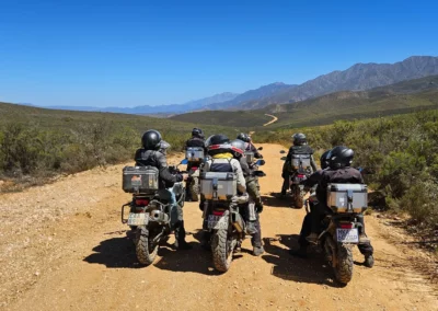 Group of adventure riders stopped on a mountain dirt road in South Africa.