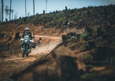 Adventure rider on a dusty off-road trail in Portugal.